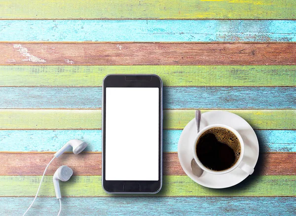 Kopp kaffe med smartphone och hörlurar — Stockfoto