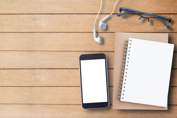 Notebook, glasses and smart phone on wood