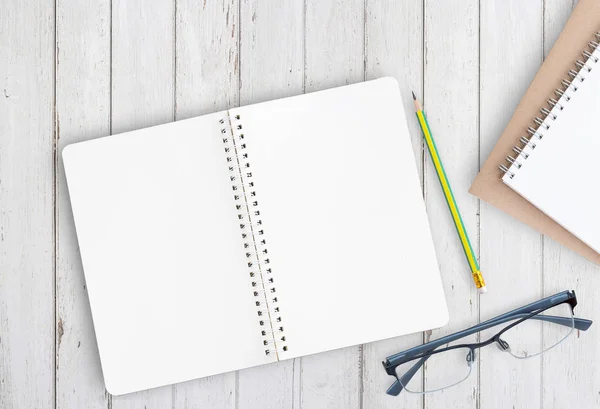 Blank notebook with pencil and glasses on office desk — Stock Photo, Image