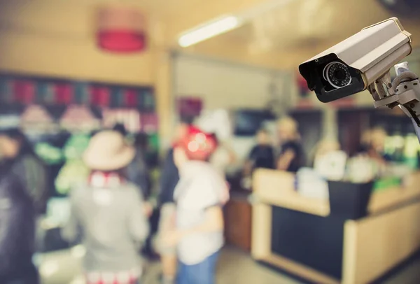 Image of CCTV security camera on blurred coffee shop background. — Stock Photo, Image