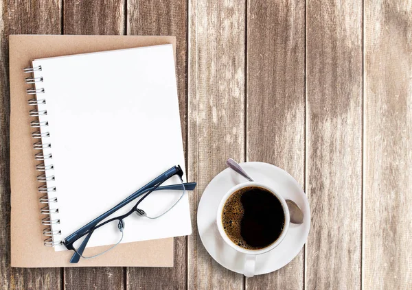 Blank notepad and glasses with cup of coffee — Stock Photo, Image