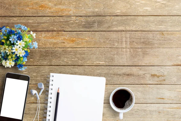 Laptop with smart phone notebook and coffee cup on workplace tab