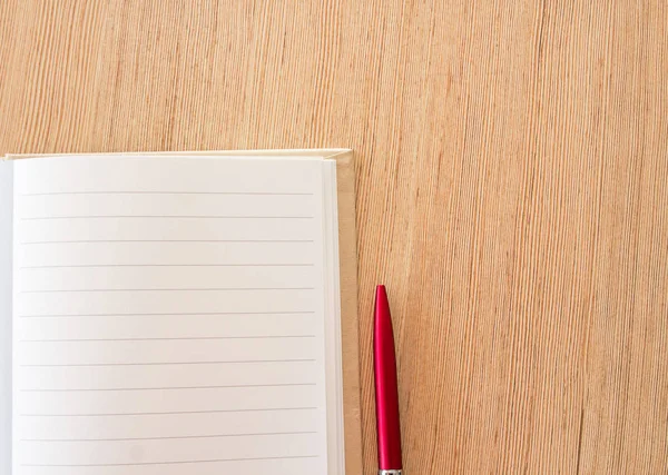 Office desk- blank notebook page and red pen on wood office tabl — Stock Photo, Image