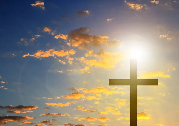 Silhouette cross in blue sky background Stock Picture