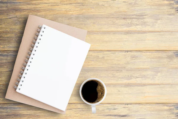 Top view blank open notebook with cup of coffee on wooden table — Stock Photo, Image