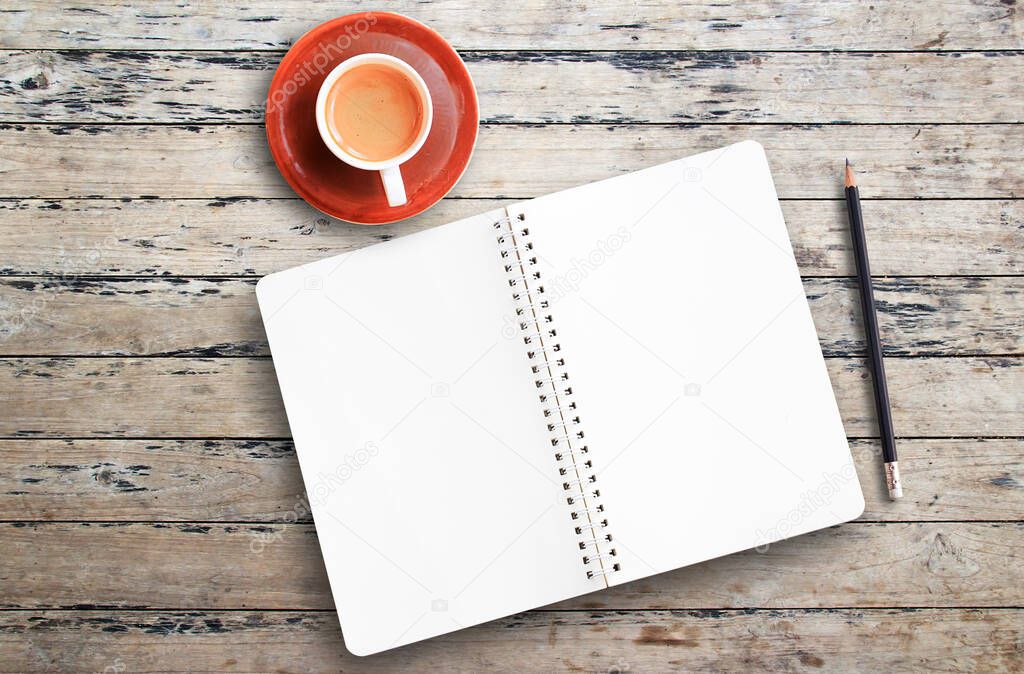 Top view with cup of coffee,pencil and notebook on wood table background in office workplace. Space for text or images design.