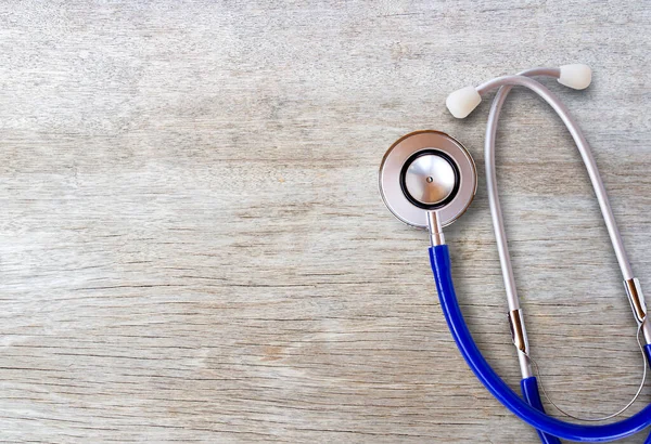 Medical healthy equipment. Workplace of a doctor. Stethoscope on wooden desk background.Top view with copy space for design. Business health and medical concept.