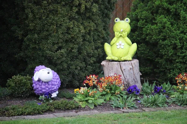 funny colorful garden figures in the flowerbed