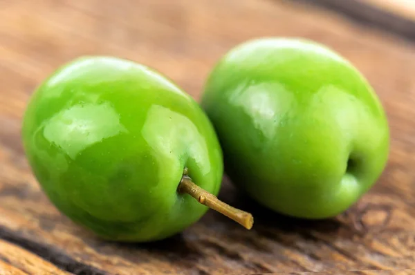 Two Delicious Green Olives Wooden Background — Stock Photo, Image