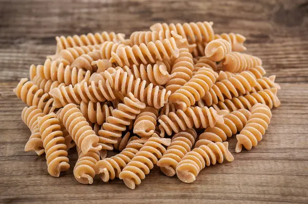 Heap of brown pasta — Stock Photo, Image