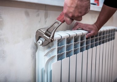 adjustable wrench repairs a heating battery