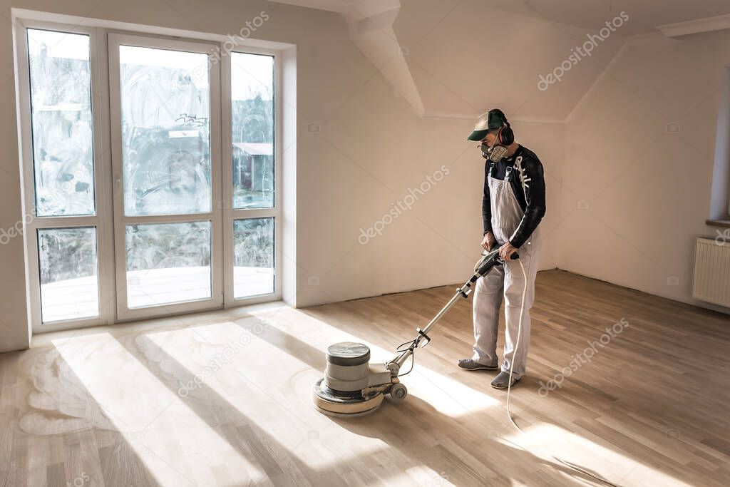 Man (master ) clean the parquet with special polishing machine