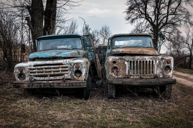Two very old rusty abandoned trucks. Post-apocalyptic photo