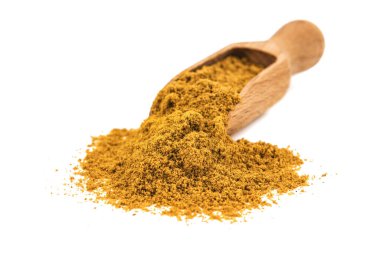 curry powder with wooden spoon scoop isolated on white