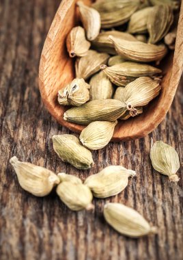 fragrant cardamom with wooden scoop