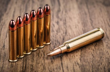 cartridges bullet of different caliber on wooden background