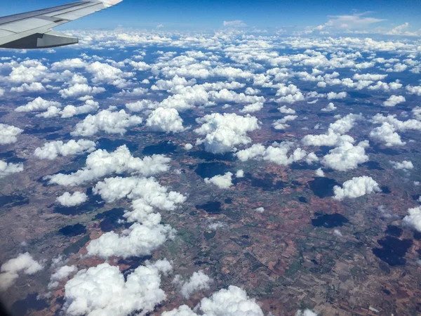 White clouds above land — Stock Photo, Image