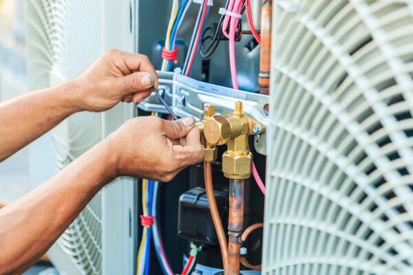 Technician preparing to install air conditioner