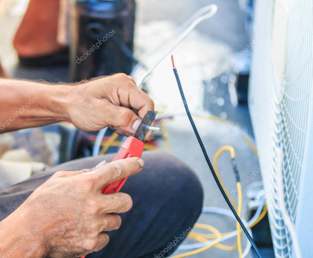 Technician preparing to install air conditioner