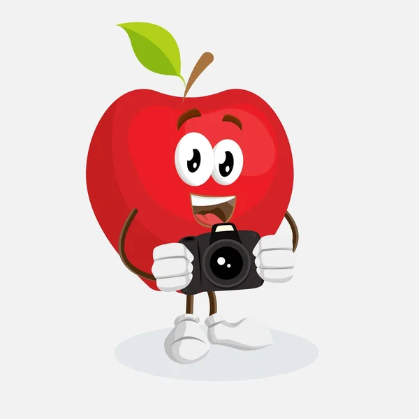 Red Apple Maskot Dan Latar Belakang Dengan Pose Kamera Dengan - Stok Vektor
