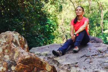 Turist oturup kuru şelale taşlar hakkında