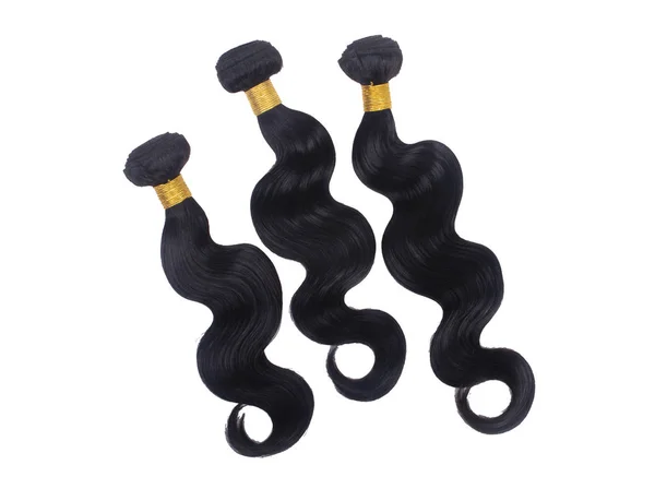 Three body wave bundles isolated on white background.  Hair extensions product stock photography.  Black 100% raw virgin human hair for weaves and sew ins.