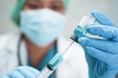Doctor holding syringe with vaccine development medical for doctor use to treat illness patients at hospital.