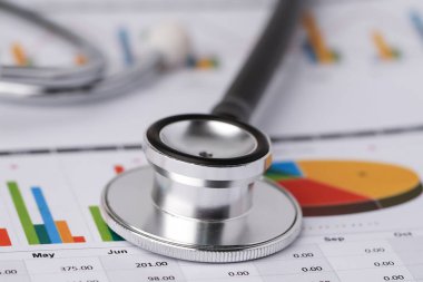 Grafik kağıdındaki steteskop: finans, hesap, istatistik, analitik ekonomi iş konsepti.
