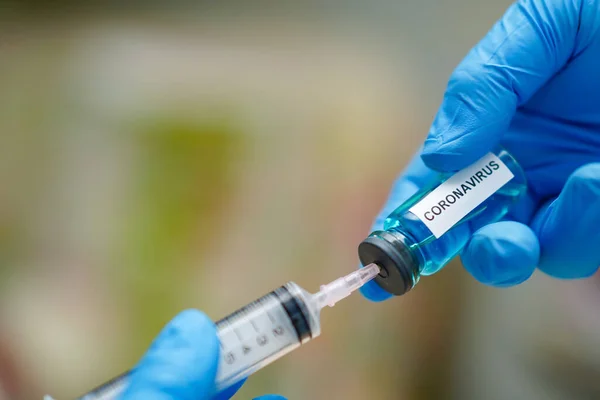 Novel Coronavirus (2019-nCoV) vaccine development medical with syringe for doctor use to treat pneumonia illness patients at Wuhan, China.