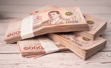 Tahta arka planda Tayland baht banknotları yığını, iş tasarrufu finans yatırım kavramı.