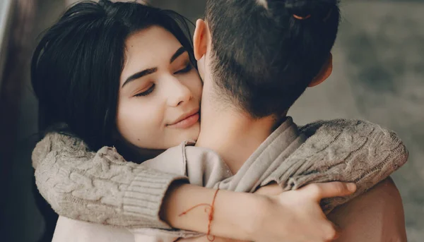 Charming caucasian girl with nice black hair embracing her lover and looking to say how much she loves him — Stock Photo, Image