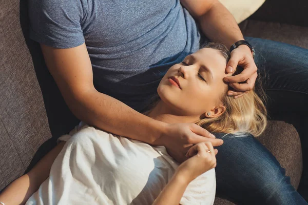 Blonde caucasian lady lying on her boyfriends knees and enjoying moments with closed eyes — Stock Photo, Image