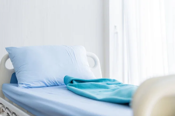 Modrá postel s prostěradlem v nemocnici. — Stock fotografie