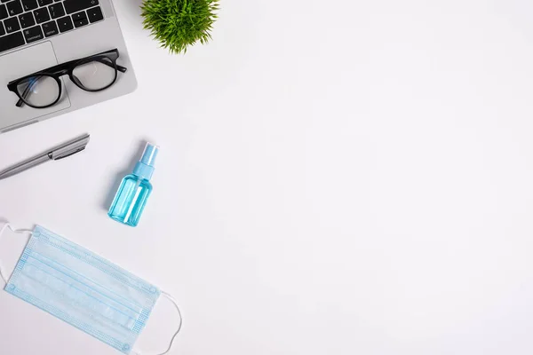 stock image The equipment to protect COVID-19, blue mask and hand cleaner gel for preparing to work from home Isolated on white background concept.