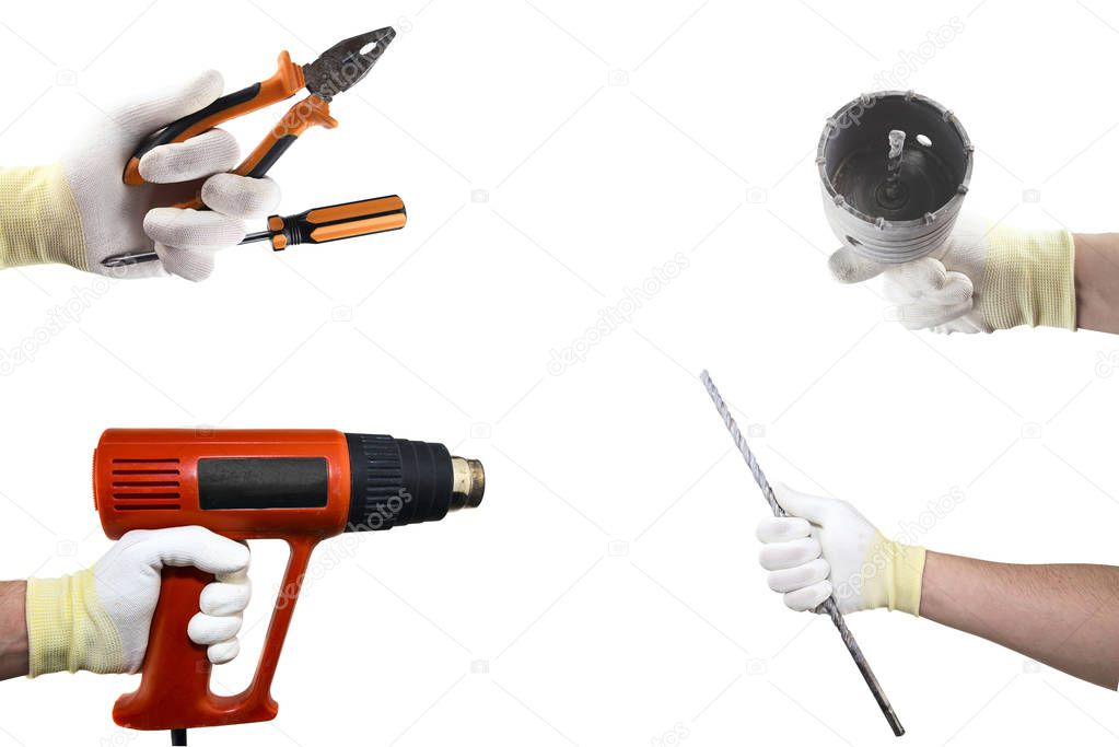 Different construction tools in the hand. Isolated on white background