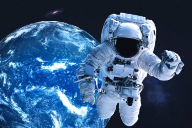 Astronaut near night Earth planet in outer space