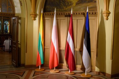 RIGA, LATVIA. 6th December 2019. Flags of Baltic States and Poland, before meeting of Baltic Prime Ministers and the Prime Minister of Poland. Small Guild, Riga. clipart