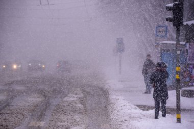 Riga, Letonya. 12 Mart 2019. Caddelerdeki araçlar, kar fırtınası sırasında Riga şehrinde kar yağışı.