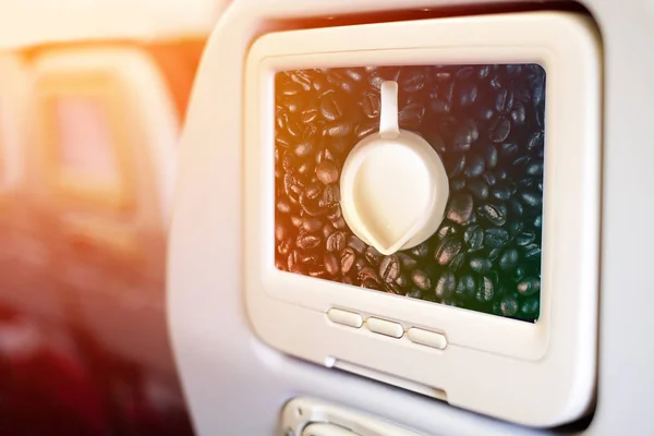 Aircraft monitor in front of passenger seat showing Capucino art — Stock Photo, Image