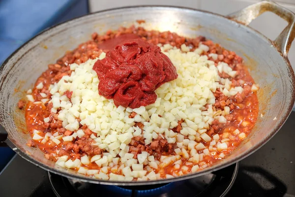 Cooking pork with red sauce and yam in home kitchen