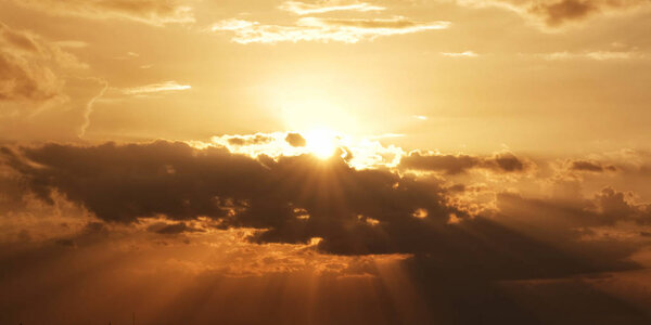 Bright sun with beams and the dark clouds