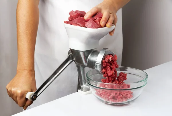 Getting minced using a meat grinder — Stock Photo, Image