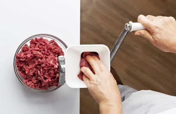 Getting minced using a meat grinder — Stock Photo, Image