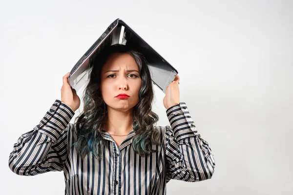 tired sad woman office worker with laptop over her head. on white