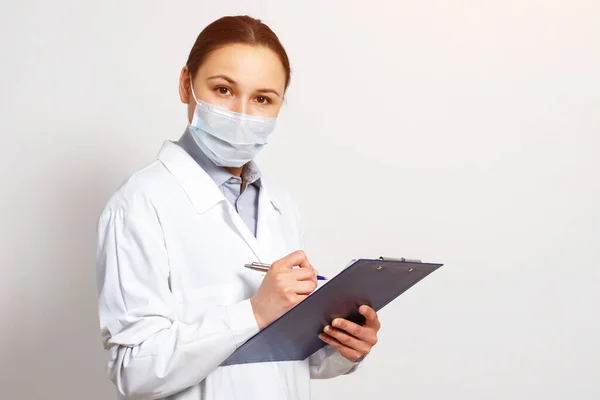 Portrait Female Doctor Protective Mask Clipboard Pen Her Hands Making — Stock Photo, Image