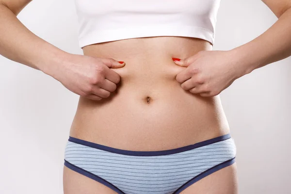 Woman Pinches Excess Fat Her Sides Belly Her Fingers White — Stock Photo, Image