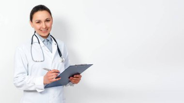 portrait of a female medical worker. Young doctor with clipboard on white background. for copyspace clipart