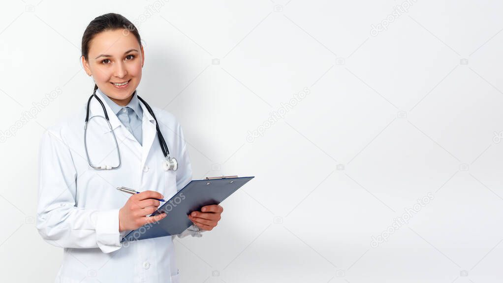 portrait of a female medical worker. Young doctor with clipboard on white background. for copyspace