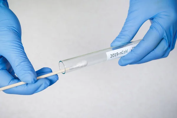 Doctor holding swab test tube for 2019-nCoV analyzing. Coronavirus test. Coronavirus and pandemic.