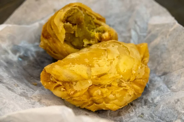 Traditional south east asian curry puff (deep fried pie filled with curry, chicken and potates)